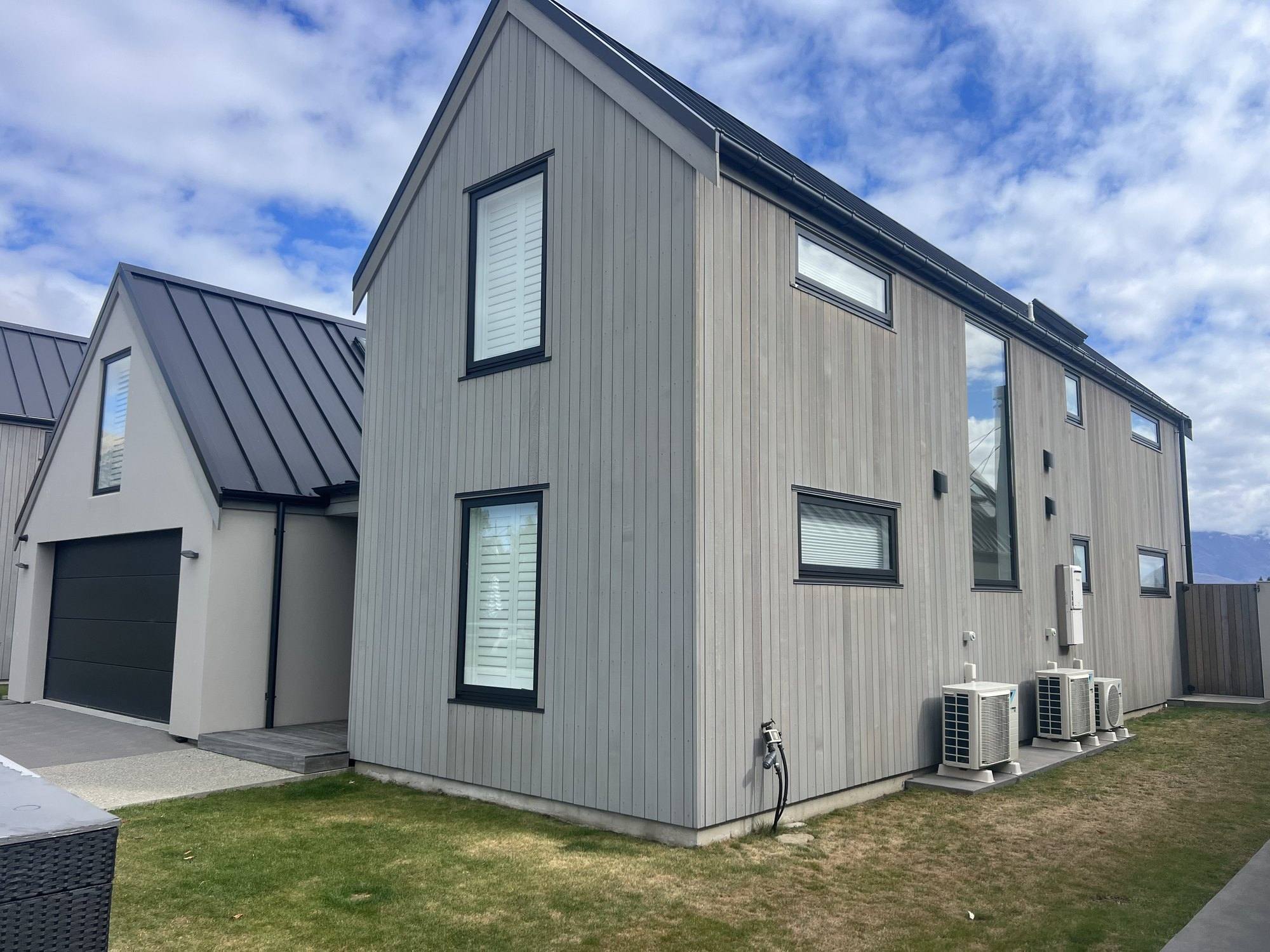 Grey cedar cladding on the side elevation of a Wānaka home