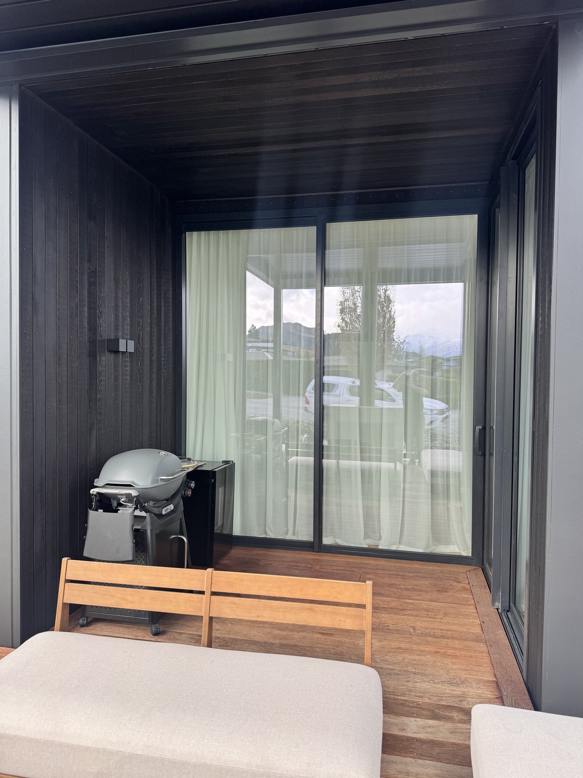 Dark-stained cedar around a sheltered outdoor living area